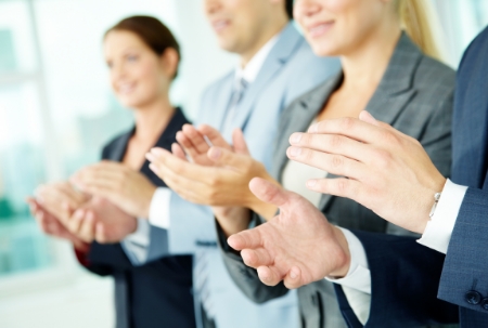 Photo of business partners hands applauding at meeting